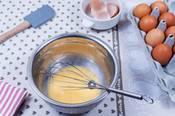 istock Beaten eggs and a hand whisk in a stainless steel bowl 836368410