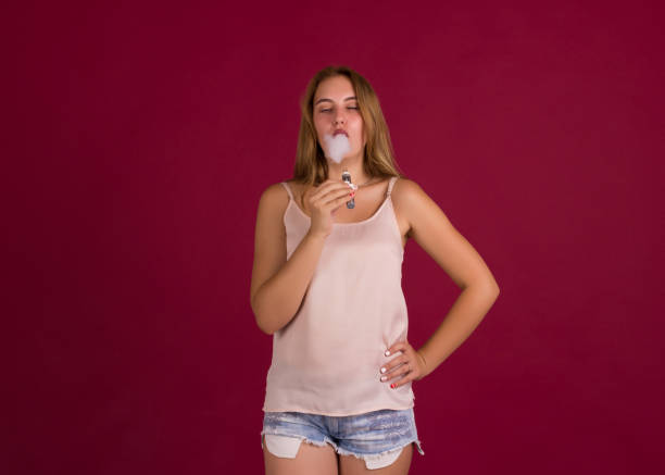 istock Young pretty girl with electronic cigarette 836369198