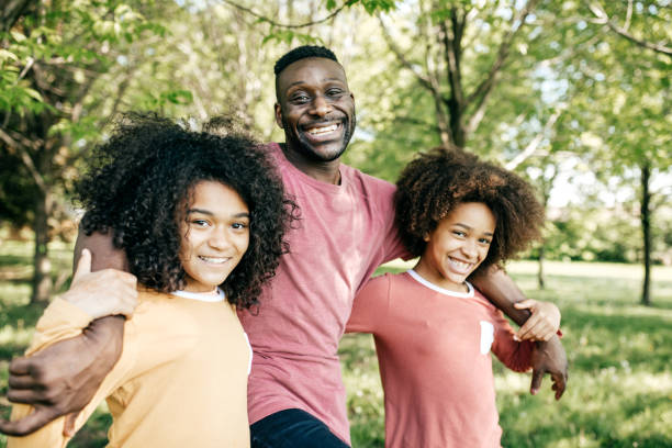 istock Dad and daughters having fun on the park 836372100