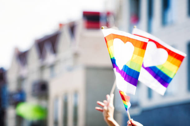 istock Montreal gay pride parade hands holding rainbow flags with heart symbol 836376016