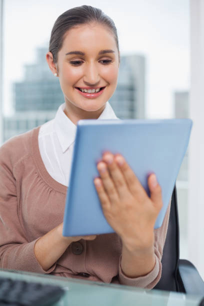 istock Happy beautiful businesswoman scrolling on her tablet 836376706
