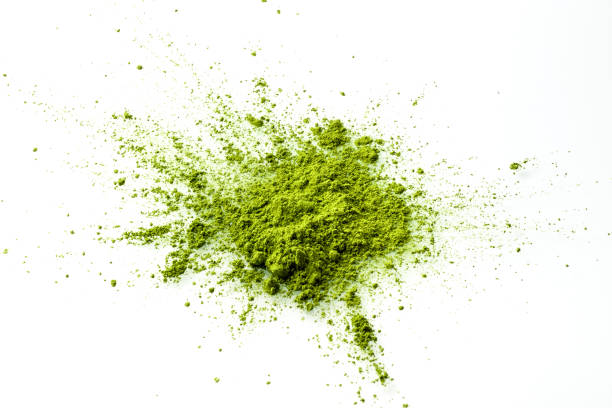 Matcha powder explosion on white background top view. Matcha powder explosion on white background top view. Matcha is made of finely ground green tea powder. It's very common in japanese culture. Matcha is healthy due to it's high antioxydant count. matcha tea photos stock pictures, royalty-free photos & images