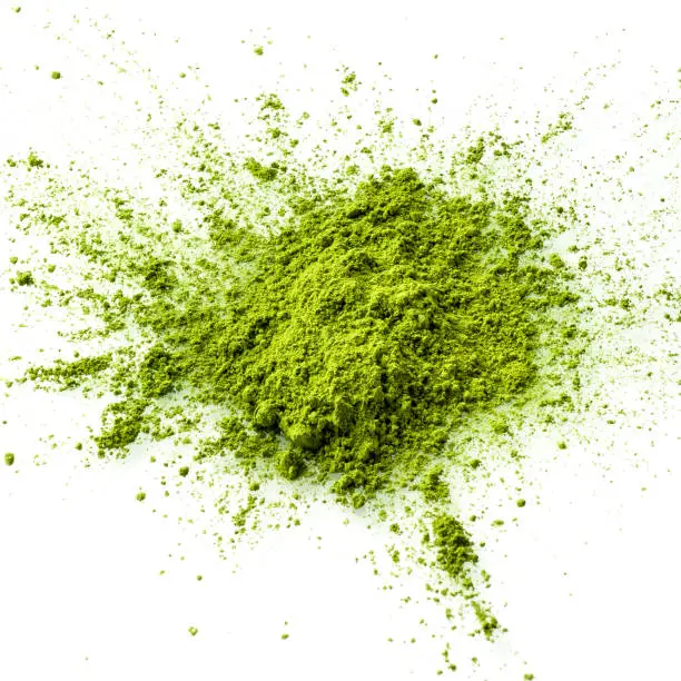 Matcha green tea powder closeup from above. Matcha is made of finely ground green tea powder. It's very common in japanese culture. Matcha is healthy due to it's high antioxydant count.
