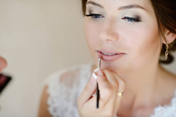 istock Wedding makeup artist making a make up for bride 836383978