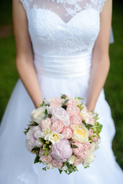 istock Beautiful bride is holding a wedding colorful bouquet 836385744