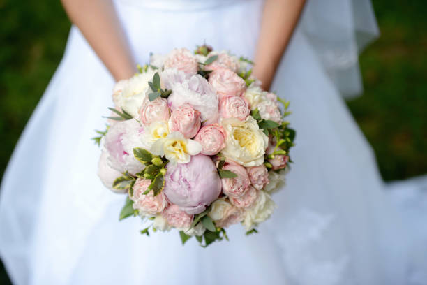 istock Beautiful bride is holding a wedding colorful bouquet 836386610