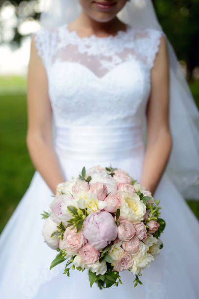 istock Beautiful bride is holding a wedding colorful bouquet 836386642