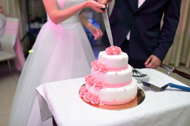 istock Beauty bride and handsome groom are cutting a wedding cake 836391466