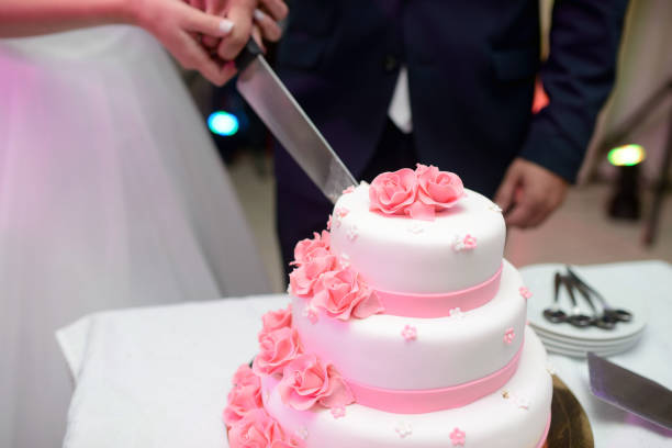 istock Beauty bride and handsome groom are cutting a wedding cake 836391534