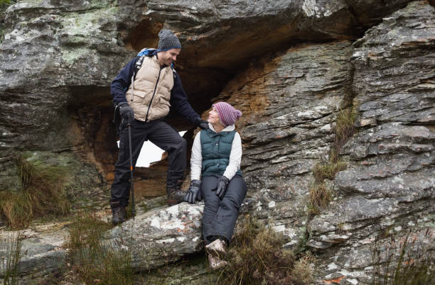 istock Young couple on rock while on a hike 836391540