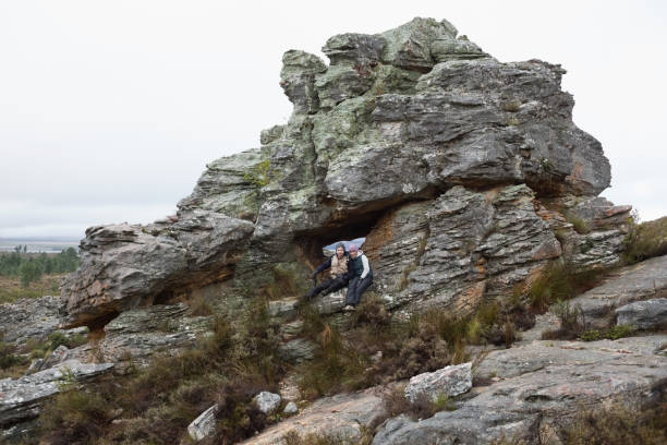 istock Young couple on huge rock while on a hike 836391580