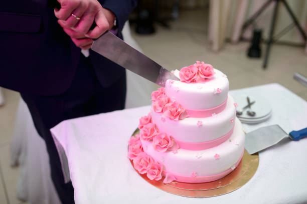 istock Beauty bride and handsome groom are cutting a wedding cake 836391586