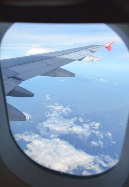 istock See through airplane's window for clounds and wing 836397712