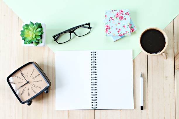 istock Top view or flat lay of open notebook paper with blank pages, accessories and coffee cup on wooden background, ready for adding or mock up 836398458