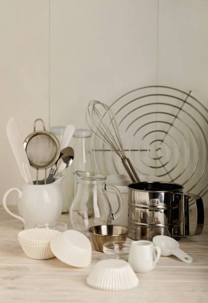 istock Kitchen tools of white and steel color (accessories) for baking on a light wooden background. 836402380