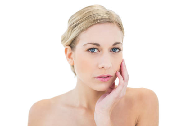 istock Attractive young blonde woman posing touching her cheek 836402946
