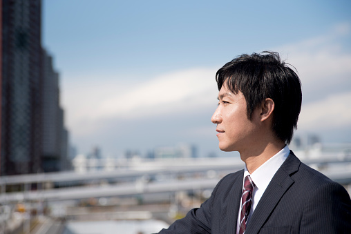 sophisticated businessman working at bay area in Tokyo,