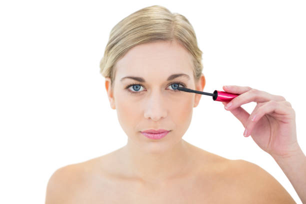 istock Concentrated young blonde woman applying mascara 836409612