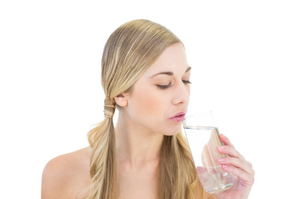 istock Stern young blonde woman drinking water 836409768