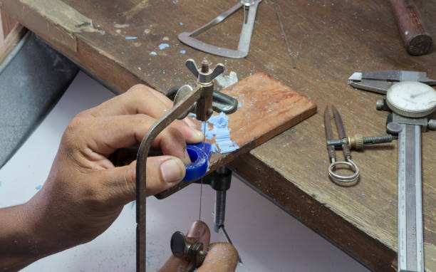 istock goldsmith use jigsaw cut wax to do ring's wax mold 836417450