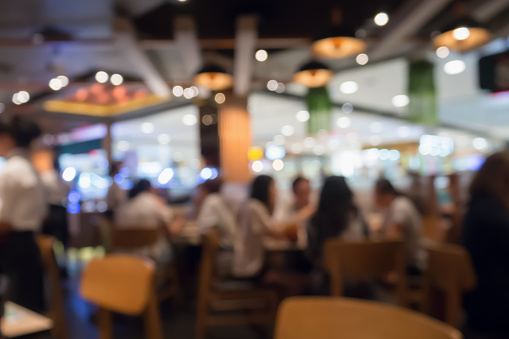 People in restaurant cafe interior with bokeh light blurred customer abstract background