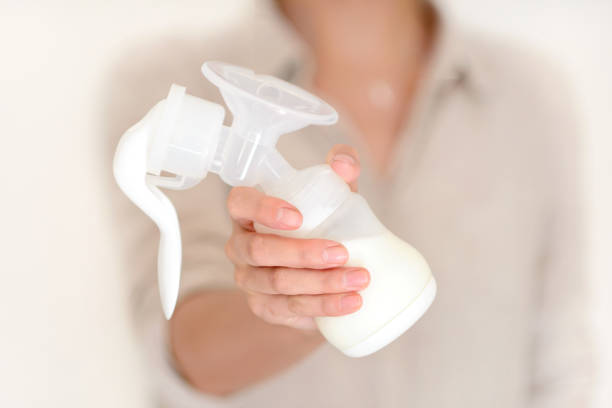istock Mother holds breast pump in her hand 836418340