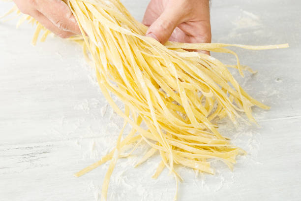 istock Man is cooking homemade noodles 836418432