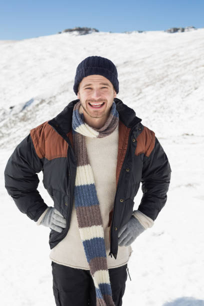 istock Man in warm clothing standing on snowed landscape 836421416