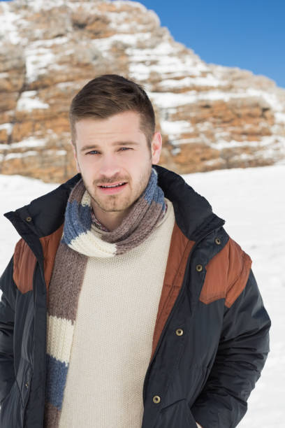 istock Man in warm clothing standing on snow covered landscape 836421494