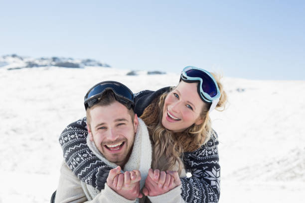 istock Cheerful couple with ski goggles on snow 836421830