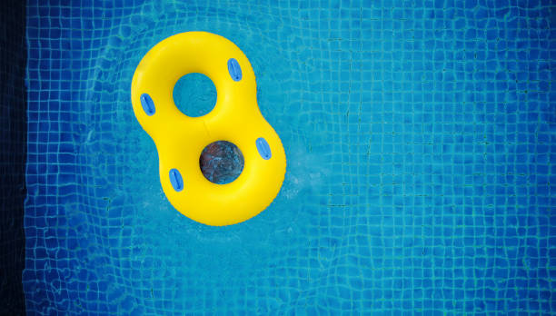 istock Yellow swim float, floating on swimming pool 836433516