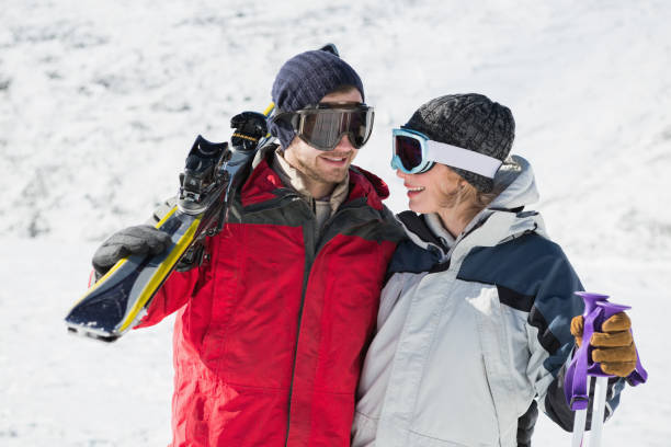 istock Happy young couple with ski boards on snow 836433564