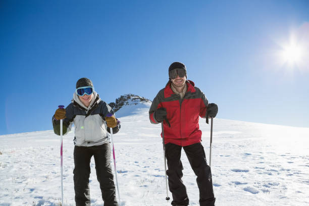 istock Skiers on snow covered landscape against blue sky 836434122