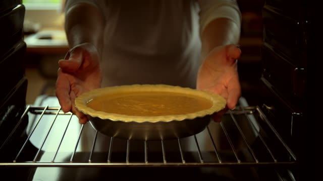 Baking Pumpkin Pie for the Holidays in the Oven - 4k Video