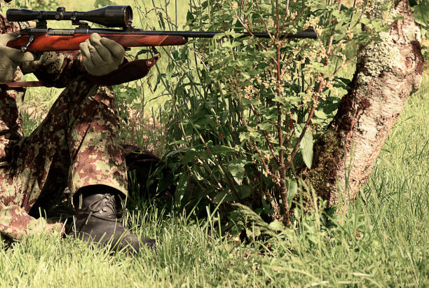 istock hunter holding the hunting carbine 836442702