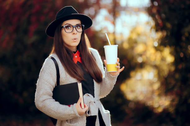 istock Surprised Female Student Holding a Hot Drink and a Book 836446252