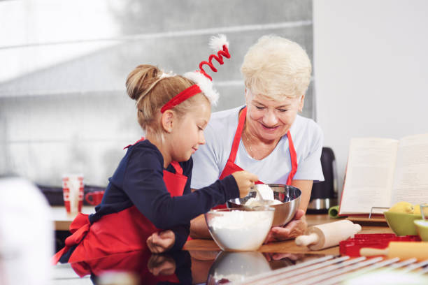 istock Grandma teaching her grandchild how to make a cake 836449892