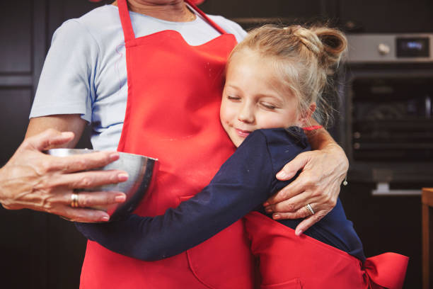 istock Granddaughter embracing her grandmother in kitchen 836450076
