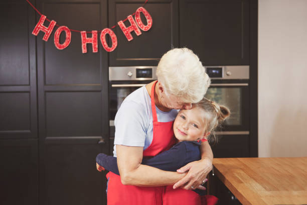 istock Grandma with granddaughter embracing in kitchen 836453290