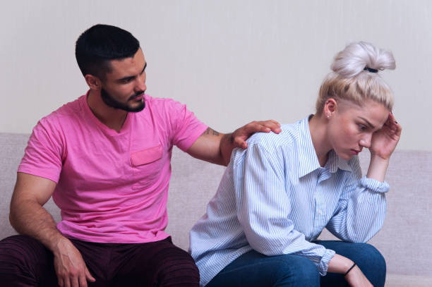 istock Young couple sitting on the couch after quarrel 836458306