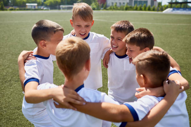 istock Junior Football Team Embracing 836460442