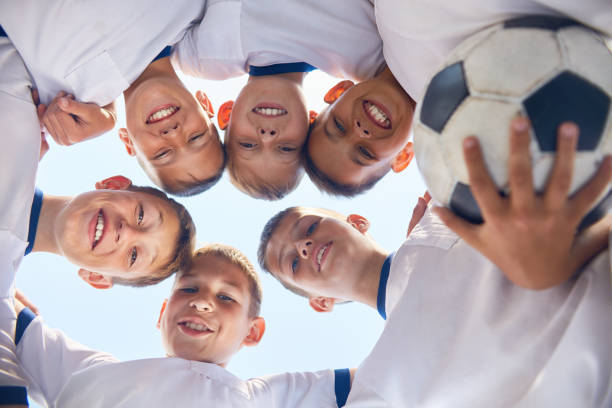 istock Junior Football Team Huddling 836460446