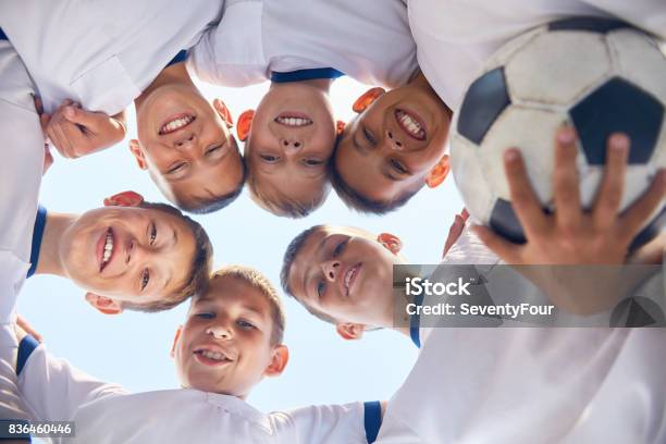 Junior Football Team Huddling Stock Photo - Download Image Now - Soccer, Friendship, Huddling