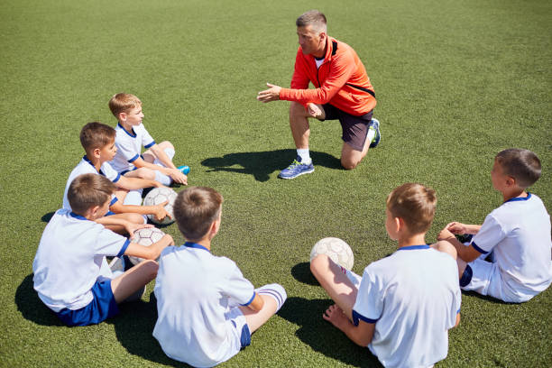 istock Coach Talking to  Junior Football Team 836460458