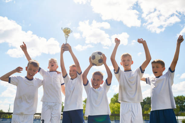 istock Boys Football Team Winning Champions Cup 836460568