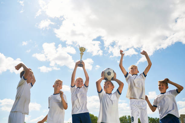 istock Junior Football Team Celebrating Victory 836460578