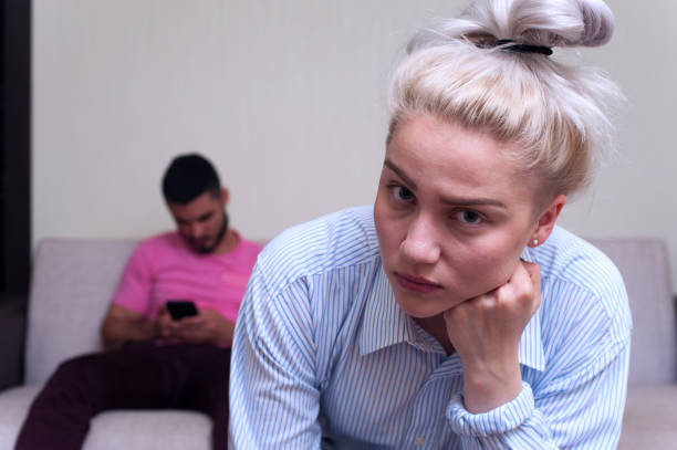 istock Young couple sitting separately at home 836460608