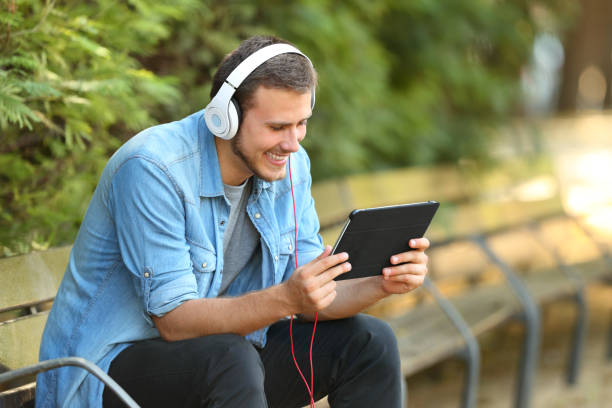 istock Guy relaxing watching videos on line in a tablet 836461576