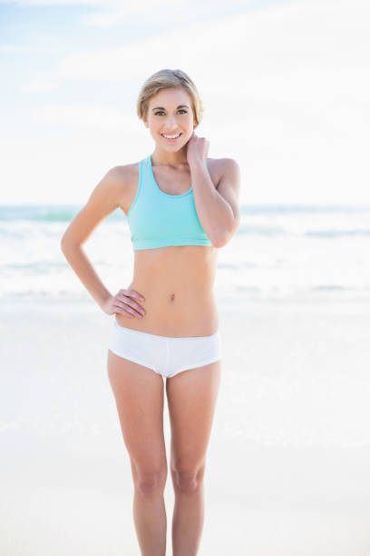 istock Smiling blonde model in sportswear posing looking at camera 836462488