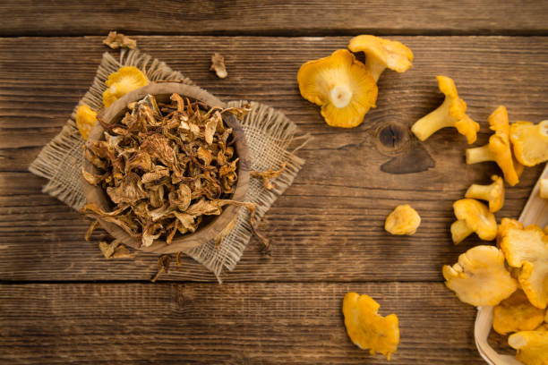 istock Portion of Dried Chanterelles on wooden background, selective focus 836465106